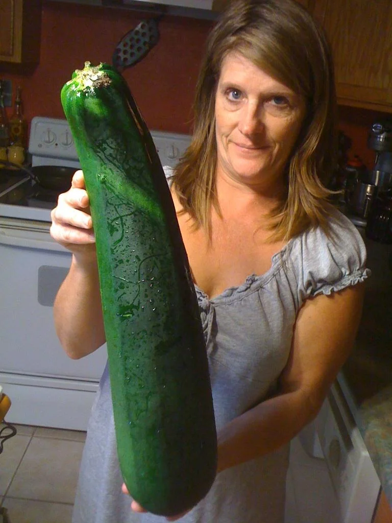 Kitchen team member showing off fresh garden produce